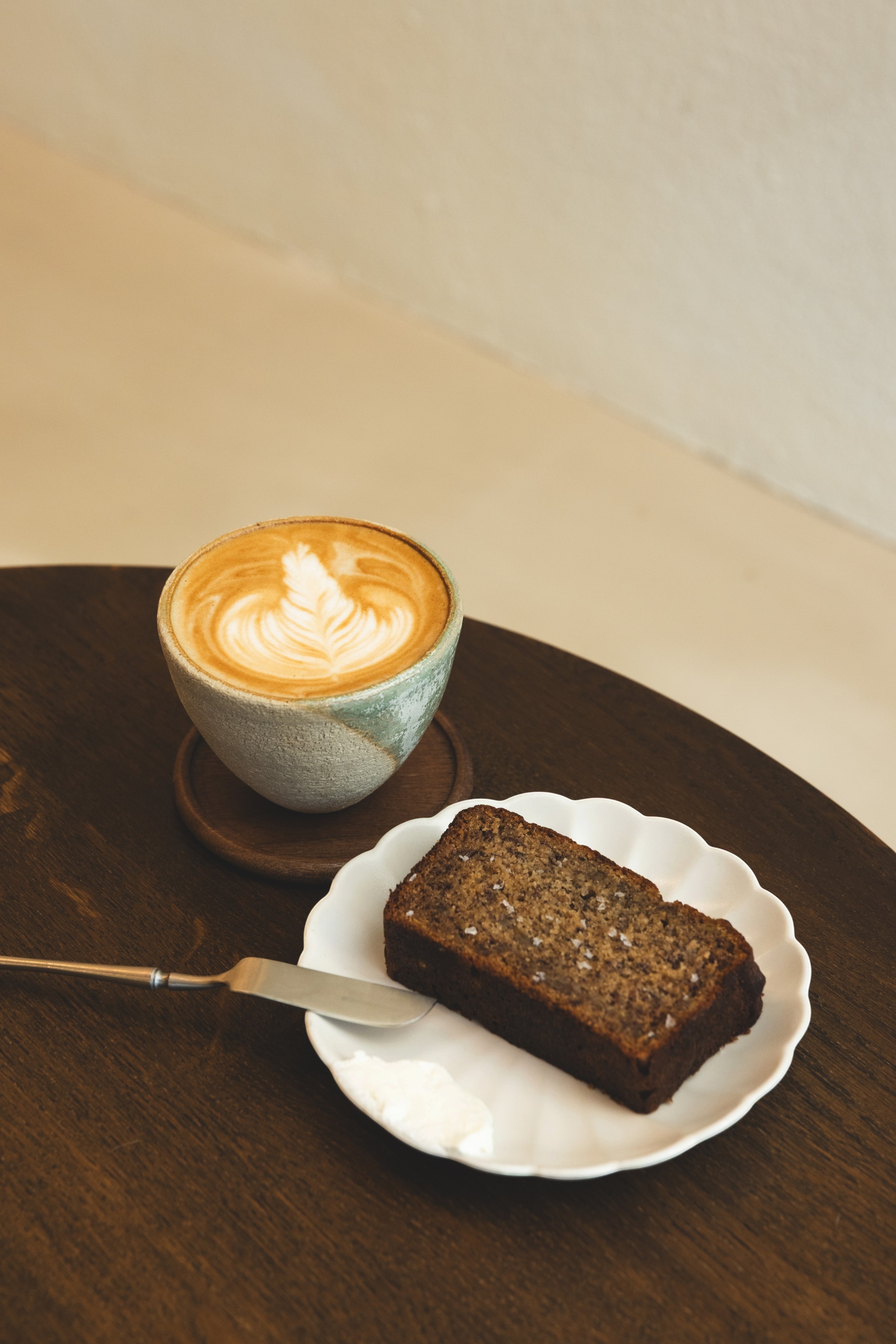 Latte art and house-made banana bread at Rakia Coffee in Jacksonville, Florida.