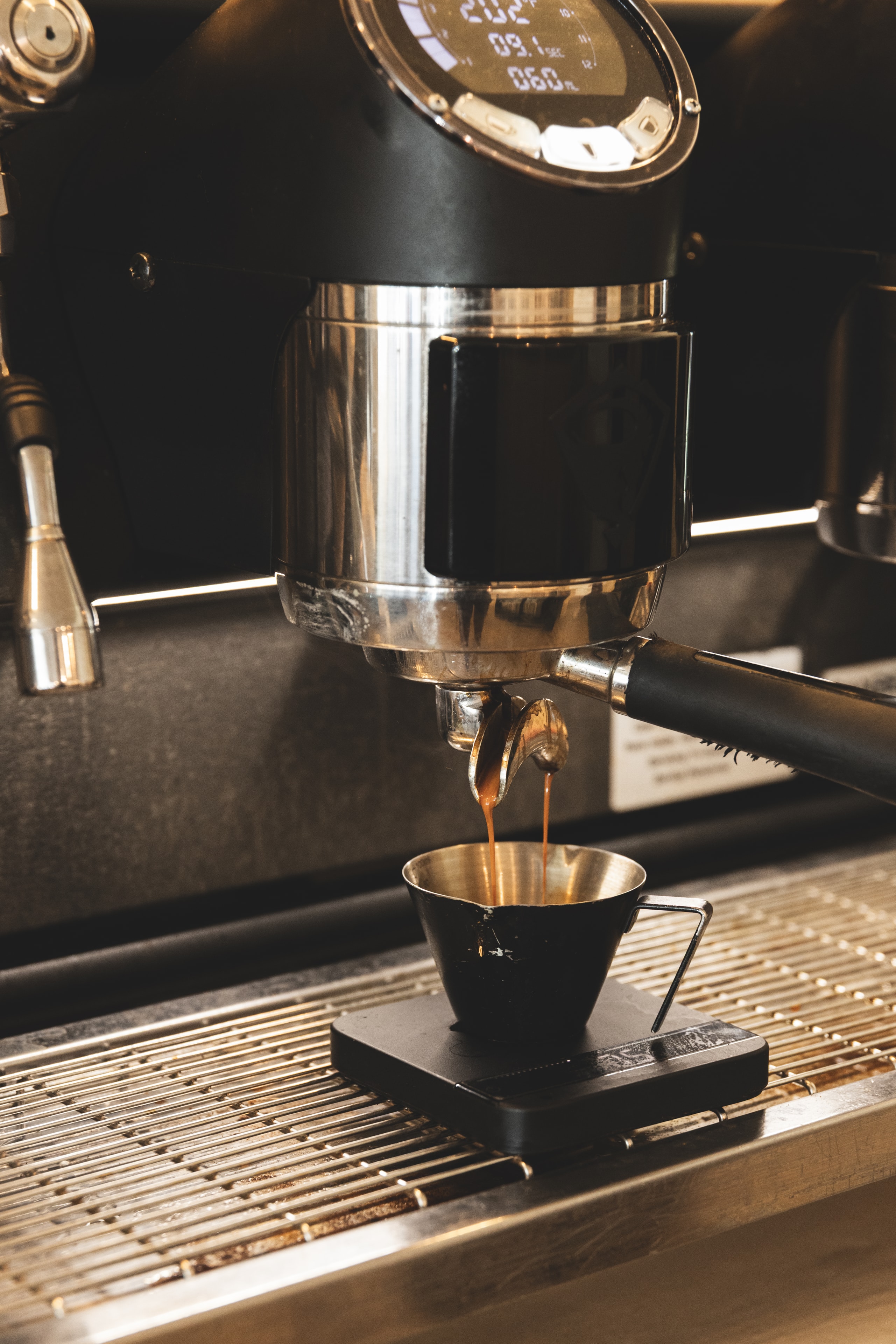 Espresso extracting from the machine into a ceramic cup at Rakia Coffee in Jacksonville.